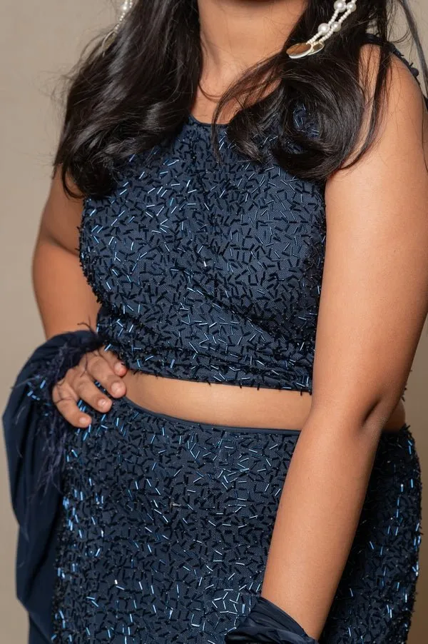 Exquisite navy blue crop top and Lahenga with intricate beadwork and dramatic sleeves, perfect for making a sophisticated statement at formal events.